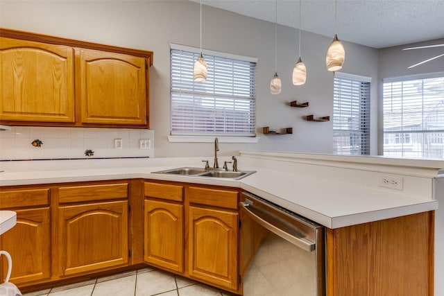 1729 Sheffield Dr, Garland, TX 75040 - kitchen featuring dishwasher, a sink, plenty of natural light, light countertops, and a textured ceiling