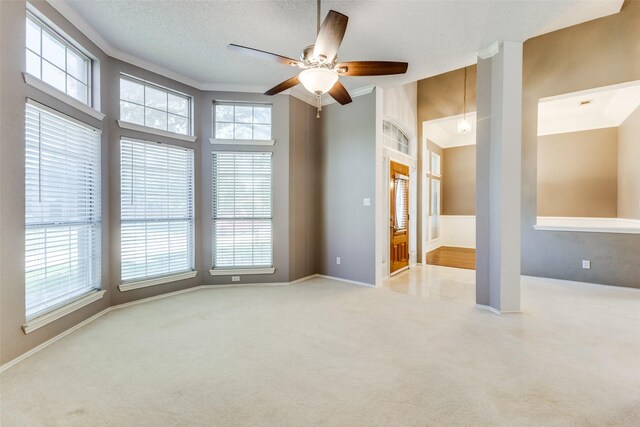 1729 Sheffield Dr, Garland, TX 75040 - carpeted spare room with a ceiling fan, plenty of natural light, ornamental molding, baseboards, and a towering ceiling