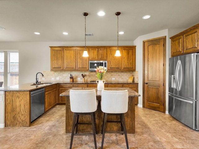 214 Crestbrook Dr, Rockwall, TX 75087 - kitchen with stainless steel appliances, brown cabinetry, a peninsula, backsplash, and recessed lighting