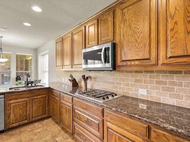 214 Crestbrook Dr, Rockwall, TX 75087 - kitchen with appliances with stainless steel finishes, a sink, brown cabinets, and recessed lighting
