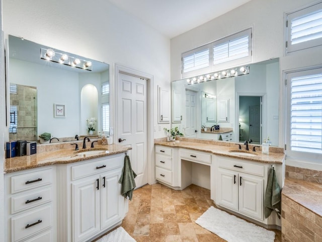 5040 Loma Alta Dr, Frisco, TX 75034 - bathroom with two vanities, healthy amount of natural light, a tile shower, and a high ceiling