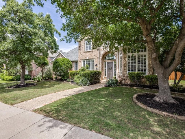 5040 Loma Alta Dr, Frisco, TX 75034 - view of front of home featuring brick siding and a front lawn