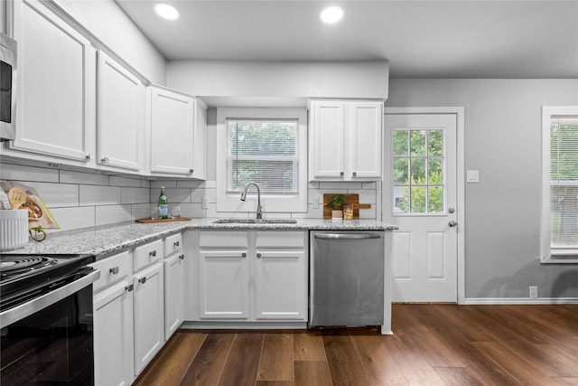 kitchen with dishwasher, a sink, black range with electric cooktop, plenty of natural light, and recessed lighting