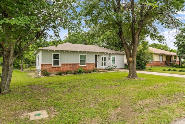 view of front of home with brick siding and a shingled roof