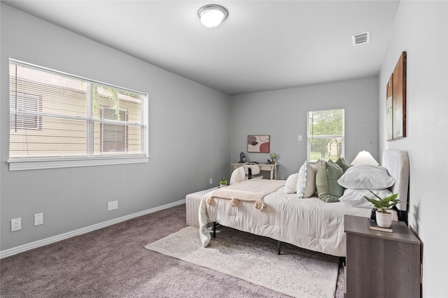carpeted bedroom featuring baseboards