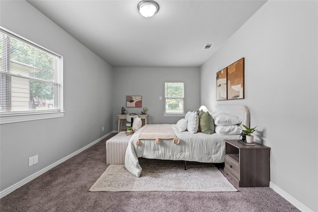 carpeted bedroom featuring baseboards