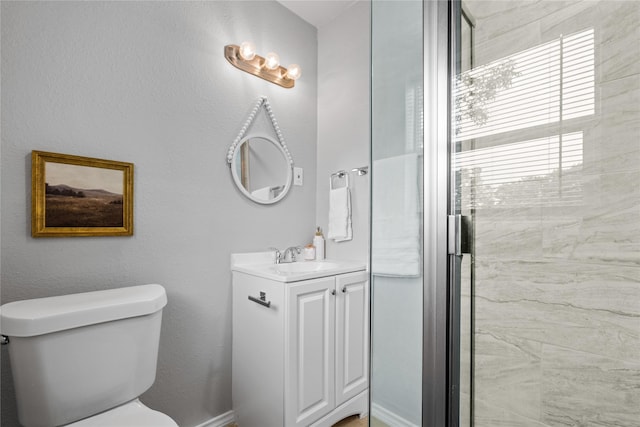 full bath featuring toilet, a stall shower, and vanity
