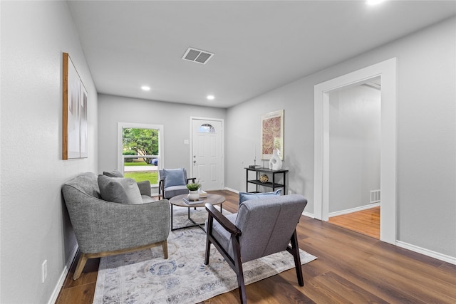 living area with wood finished floors, baseboards, and recessed lighting