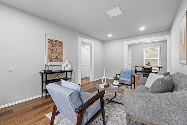 living area featuring wood finished floors, baseboards, and recessed lighting