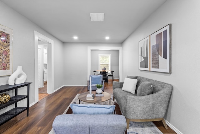 living room with dark wood-style floors, baseboards, and recessed lighting