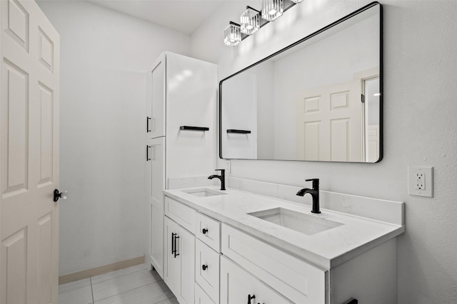 807 S Edgefield Ave, Dallas, TX 75208 - full bathroom with double vanity, baseboards, and tile patterned flooring