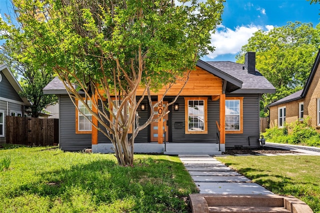 807 S Edgefield Ave, Dallas, TX 75208 - view of front of house featuring a chimney, covered porch, and roof with shingles