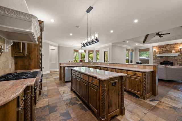 113 Welford Ln, Southlake, TX 76092 - kitchen with ornamental molding, a large island, ceiling fan, stainless steel dishwasher, and stone tile flooring