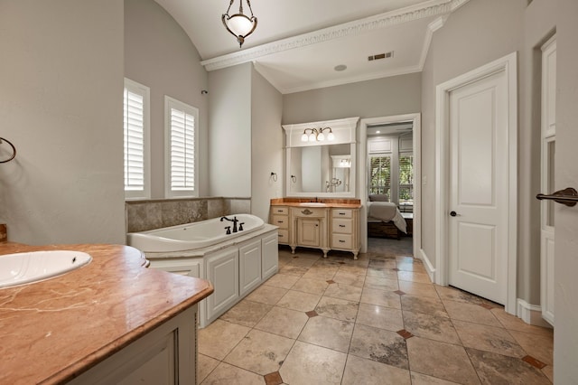 113 Welford Ln, Southlake, TX 76092 - bathroom featuring two vanities, a bath, crown molding, and vaulted ceiling