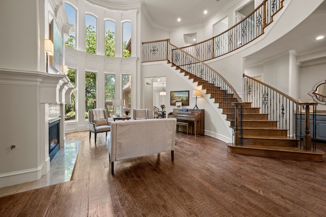 113 Welford Ln, Southlake, TX 76092 - living room with a towering ceiling, stairway, a fireplace with flush hearth, baseboards, and ornamental molding