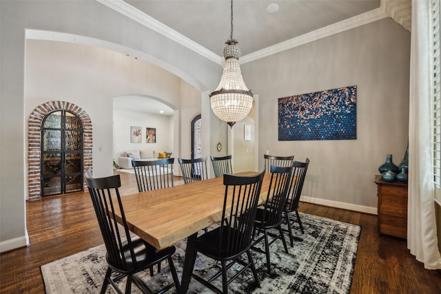 6005 Arboretum Dr, Frisco, TX 75034 - dining area featuring arched walkways, wood finished floors, baseboards, crown molding, and a chandelier
