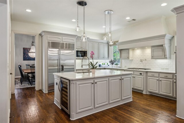 6005 Arboretum Dr, Frisco, TX 75034 - kitchen with wine cooler, built in appliances, a sink, tasteful backsplash, and crown molding