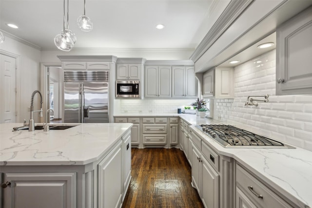 6005 Arboretum Dr, Frisco, TX 75034 - kitchen featuring built in appliances, a sink, crown molding, decorative backsplash, and decorative light fixtures