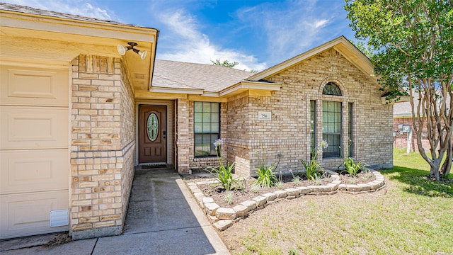750 S First Ave, Stephenville, TX 76401 - doorway to property featuring a lawn, roof with shingles, and brick siding