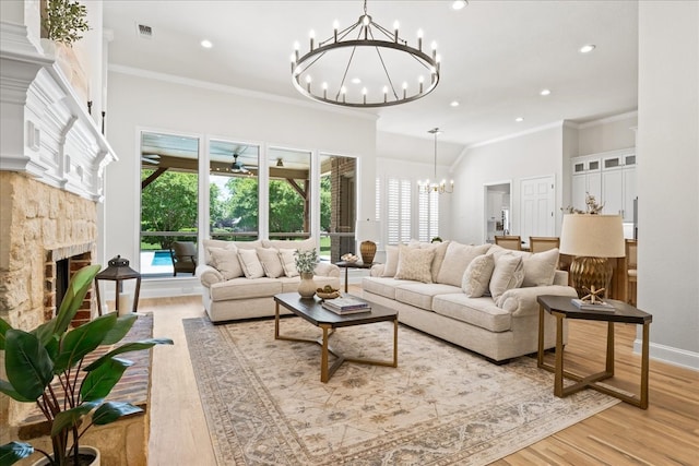 1740 Highland Meadows Dr, Prosper, TX 75078 - living room featuring a chandelier, crown molding, light wood-style floors, plenty of natural light, and a fireplace