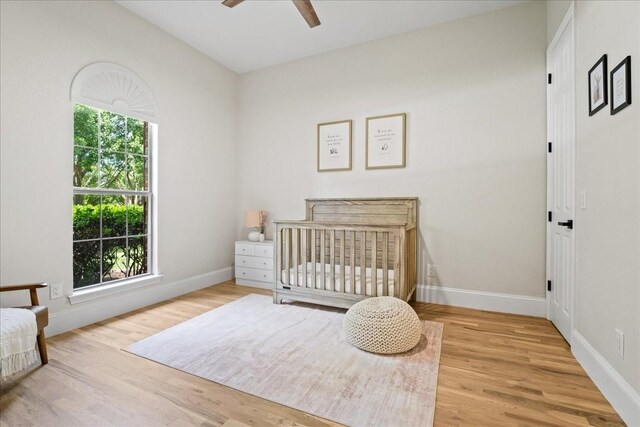 1740 Highland Meadows Dr, Prosper, TX 75078 - bedroom with wood finished floors, baseboards, and a crib