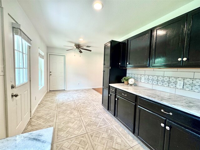 2305 Joey Dr, Waco, TX 76711 - kitchen with dark cabinetry, a ceiling fan, tasteful backsplash, and recessed lighting