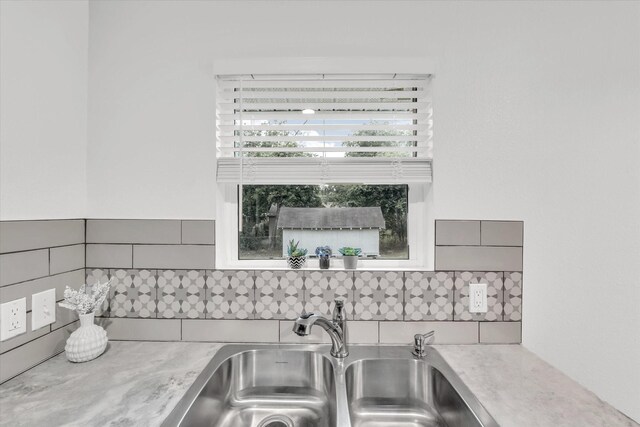 2305 Joey Dr, Waco, TX 76711 - kitchen view of a sink, backsplash, light countertops, and gray cabinetry