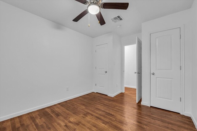 2305 Joey Dr, Waco, TX 76711 - unfurnished bedroom featuring baseboards, wood finished floors, and a ceiling fan