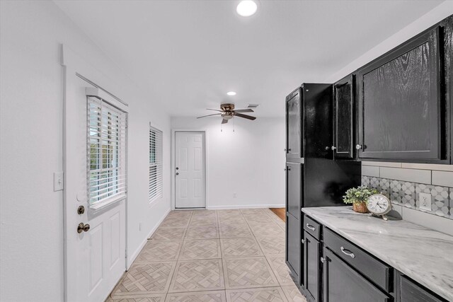 2305 Joey Dr, Waco, TX 76711 - kitchen with a ceiling fan, dark cabinets, tasteful backsplash, recessed lighting, and baseboards