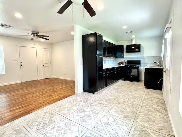2305 Joey Dr, Waco, TX 76711 - kitchen featuring black appliances, dark cabinets, ceiling fan, a sink, and recessed lighting