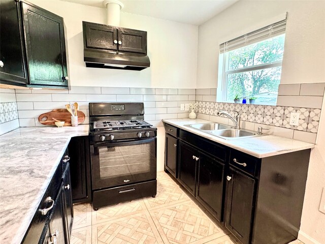 2305 Joey Dr, Waco, TX 76711 - kitchen with black gas stove, a sink, light countertops, tasteful backsplash, and under cabinet range hood