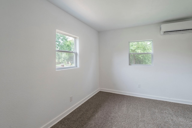 2612 S Oak Trl, Granbury, TX 76048 - empty room featuring a wall unit AC, dark colored carpet, and baseboards