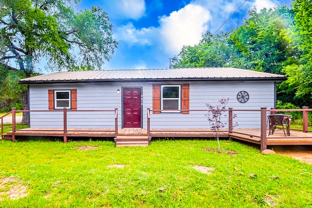 2612 S Oak Trl, Granbury, TX 76048 - view of front of home with a wooden deck, a front lawn, and metal roof