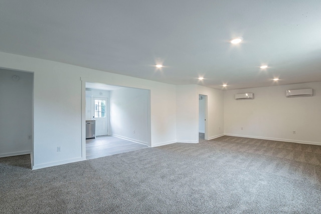 2612 S Oak Trl, Granbury, TX 76048 - unfurnished room featuring a wall unit AC, carpet floors, baseboards, and recessed lighting