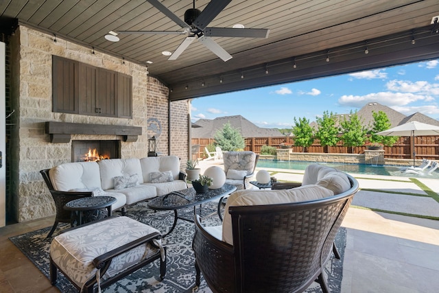 412 Appaloosa Run, Argyle, TX 76226 - view of patio featuring ceiling fan, a fenced backyard, and an outdoor living space with a fireplace