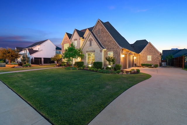 412 Appaloosa Run, Argyle, TX 76226 - french provincial home with an attached garage, driveway, brick siding, stone siding, and central AC unit