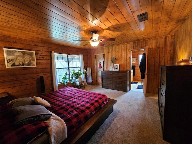 2488 Fm 2138 N, Jacksonville, TX 75766 - bedroom featuring light colored carpet, wood walls, wooden ceiling, and a ceiling fan
