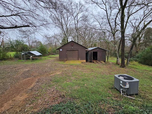 2488 Fm 2138 N, Jacksonville, TX 75766 - view of yard featuring an outbuilding, cooling unit, and a garage