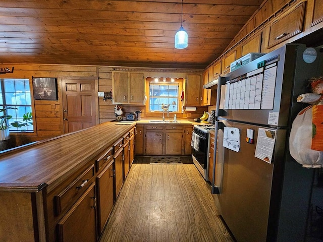 2488 Fm 2138 N, Jacksonville, TX 75766 - kitchen with freestanding refrigerator, butcher block counters, wood ceiling, brown cabinets, and wood finished floors