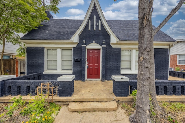 2741 Ivandell Ave, Dallas, TX 75211 - view of front of property with brick siding, a shingled roof, and fence