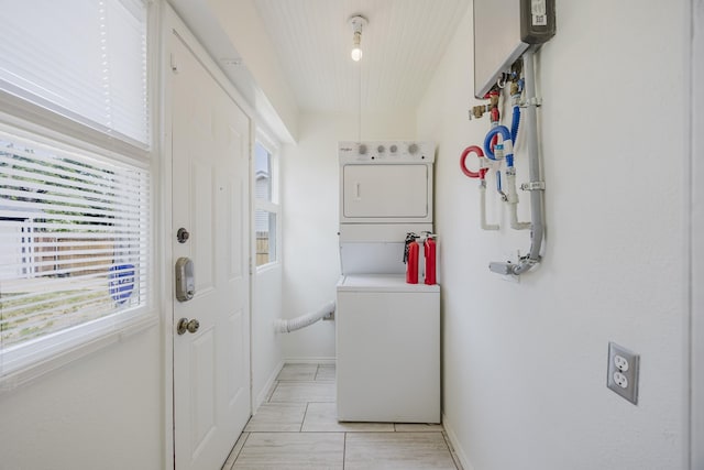 2741 Ivandell Ave, Dallas, TX 75211 - washroom with estacked washer and dryer, baseboards, and water heater