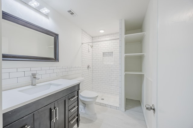 2741 Ivandell Ave, Dallas, TX 75211 - full bath with a shower stall, toilet, vanity, tile patterned floors, and tile walls