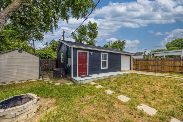2741 Ivandell Ave, Dallas, TX 75211 - view of outbuilding featuring central AC unit, an outbuilding, a fire pit, and driveway