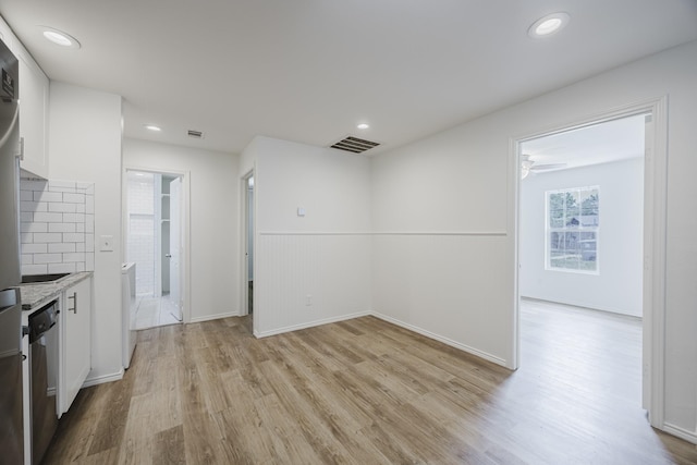 2741 Ivandell Ave, Dallas, TX 75211 - kitchen with white cabinetry, light wood finished floors, dishwasher, light countertops, and recessed lighting