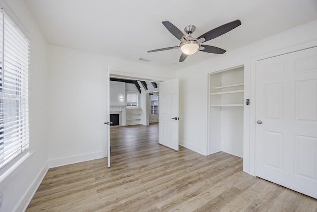 2741 Ivandell Ave, Dallas, TX 75211 - unfurnished bedroom featuring light wood finished floors, a closet, baseboards, and a ceiling fan