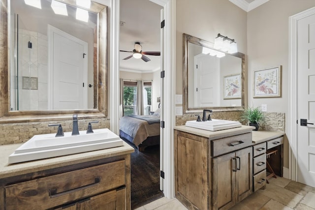 ensuite bathroom featuring ornamental molding, two vanities, ceiling fan, and backsplash