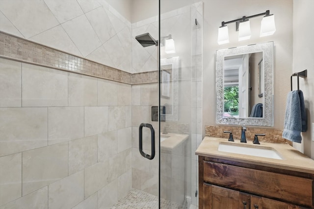 full bath featuring a stall shower and vanity