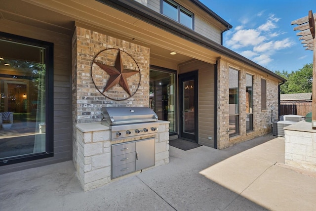 view of patio / terrace featuring exterior kitchen and grilling area
