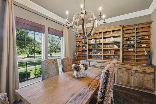 dining space with a chandelier, crown molding, and healthy amount of natural light