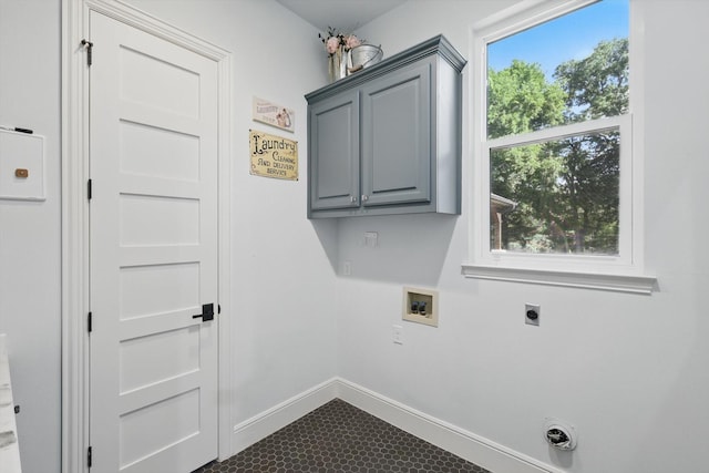 clothes washing area with electric dryer hookup, hookup for a washing machine, cabinet space, and baseboards